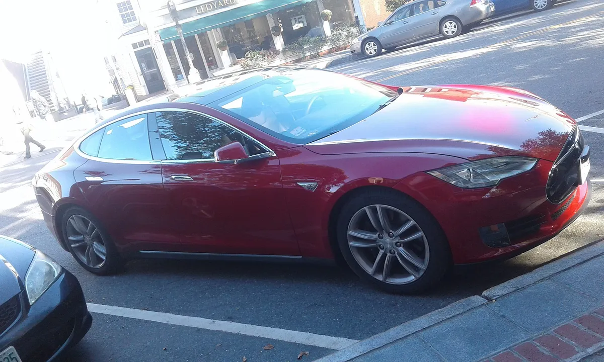 Red Tesla Model S in a metered parking spot on Main Street in downtown Hanover, New Hampshire